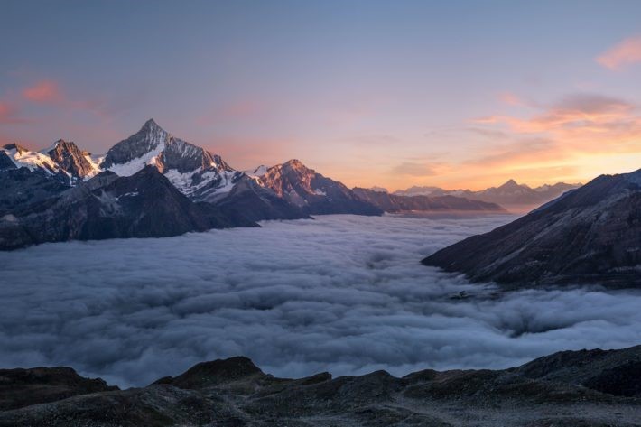 Mountains above clouds at sunrise